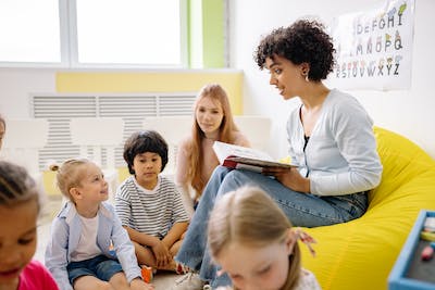 adult/teacher reading to young children