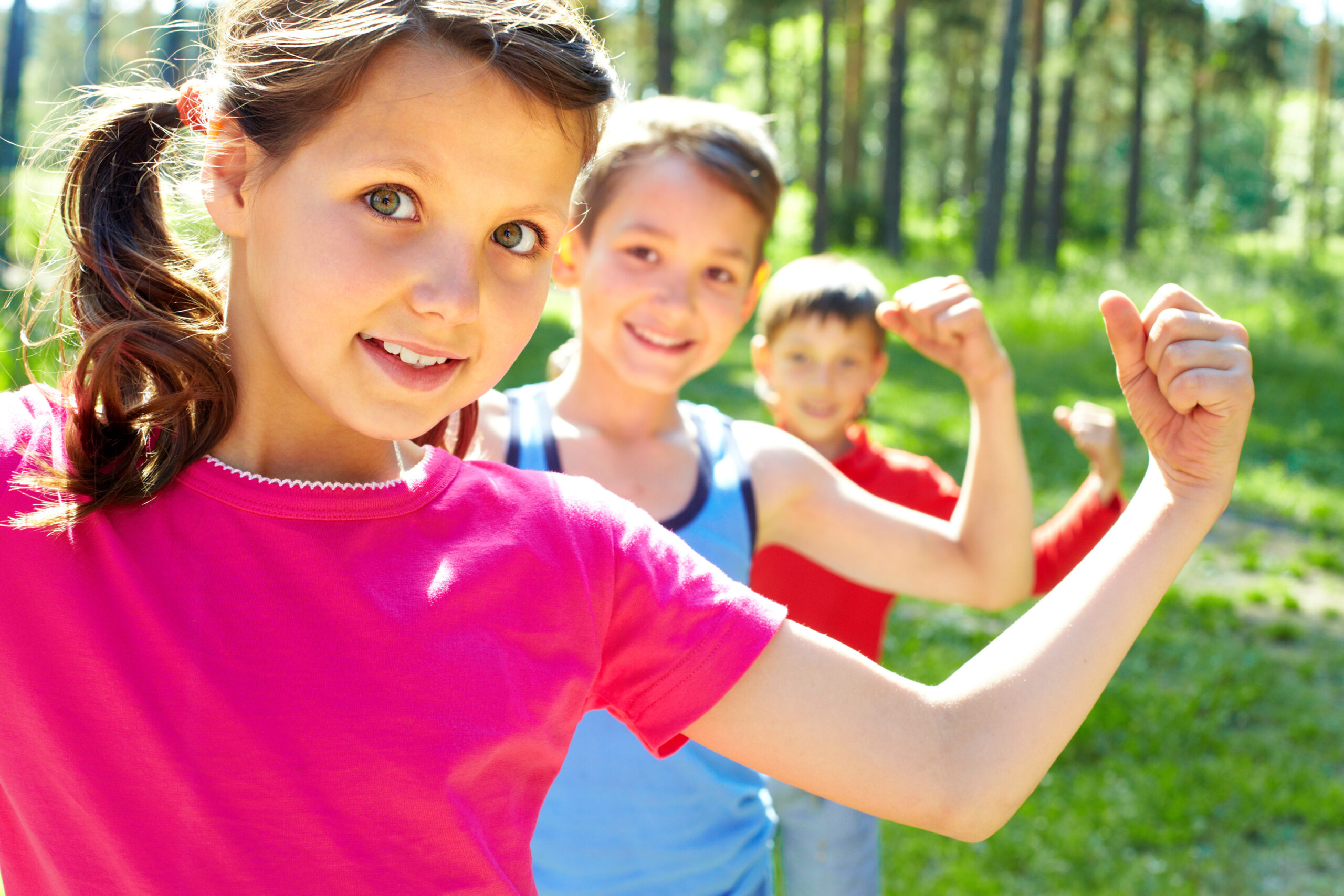 row of kids making bicep muscles