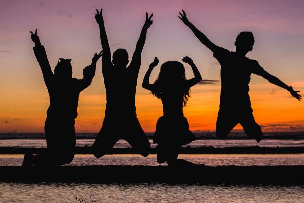 silhouette of kids jumping