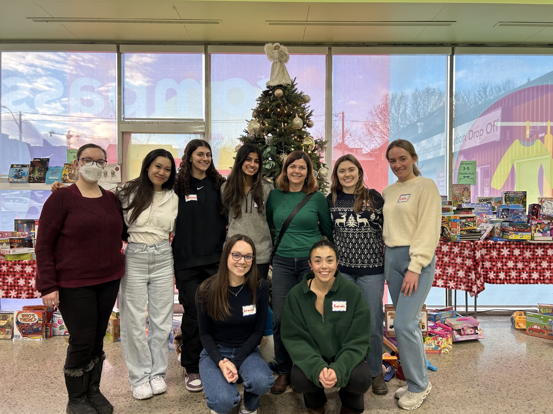 Elyse, Megan, Amoren, Kanika, Meighan, Avery, Lidia. Grace, Sarah in front of Christmas tree